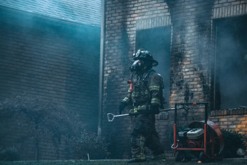 Firefighter leaving the scene of a house fire