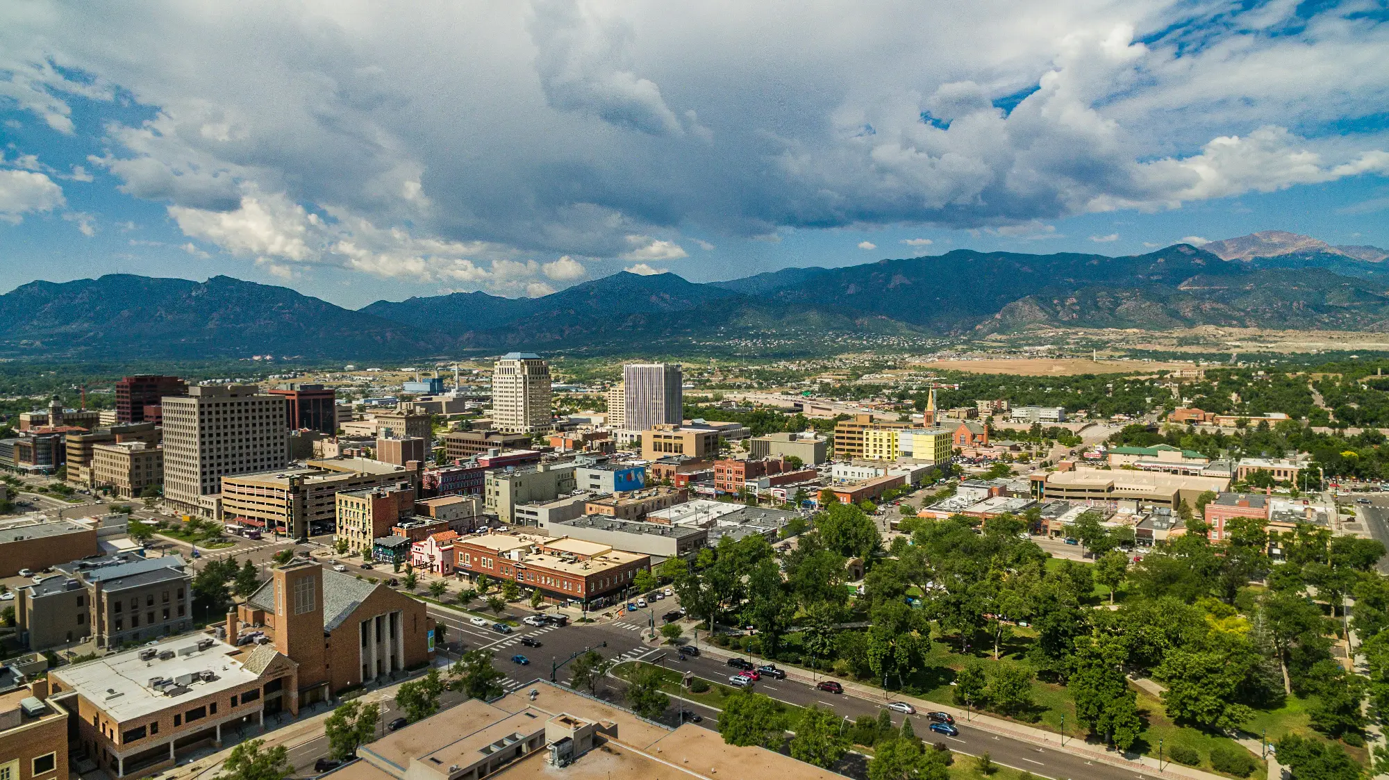 Aerial photo of Colorado Springs with mountains in the background